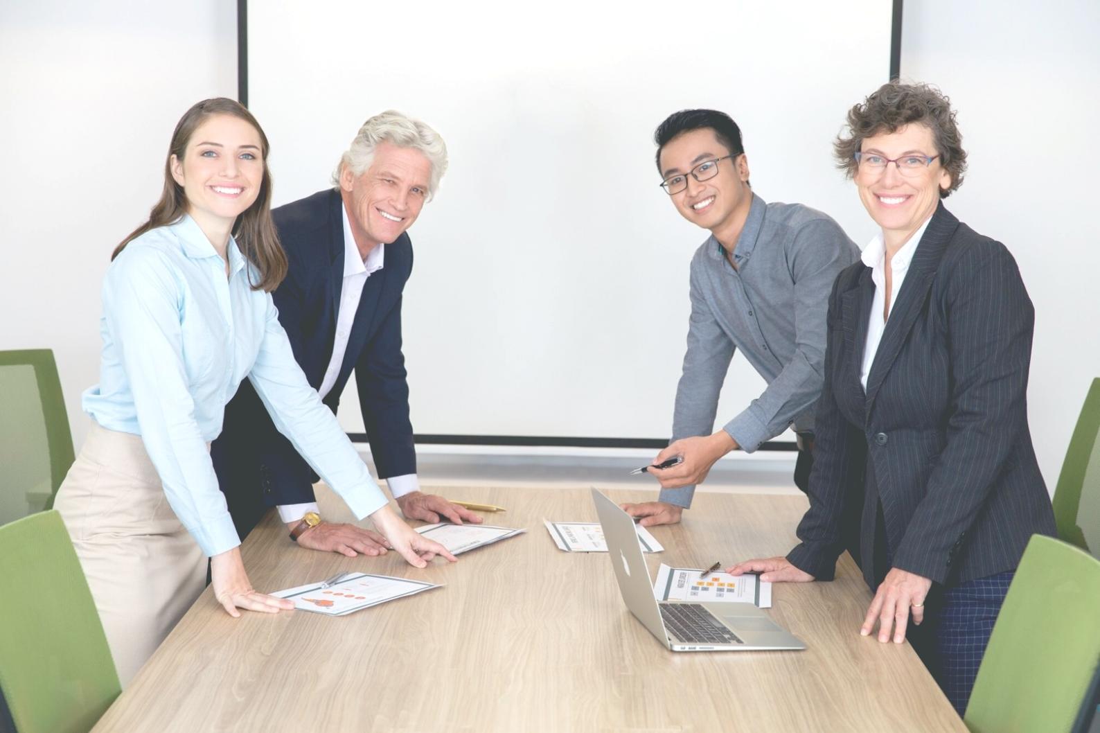 Business partnership meeting with financial documents and progress charts